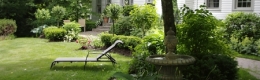  In the front garden under a large linden trickles a fountain accompanied by lounge chair 